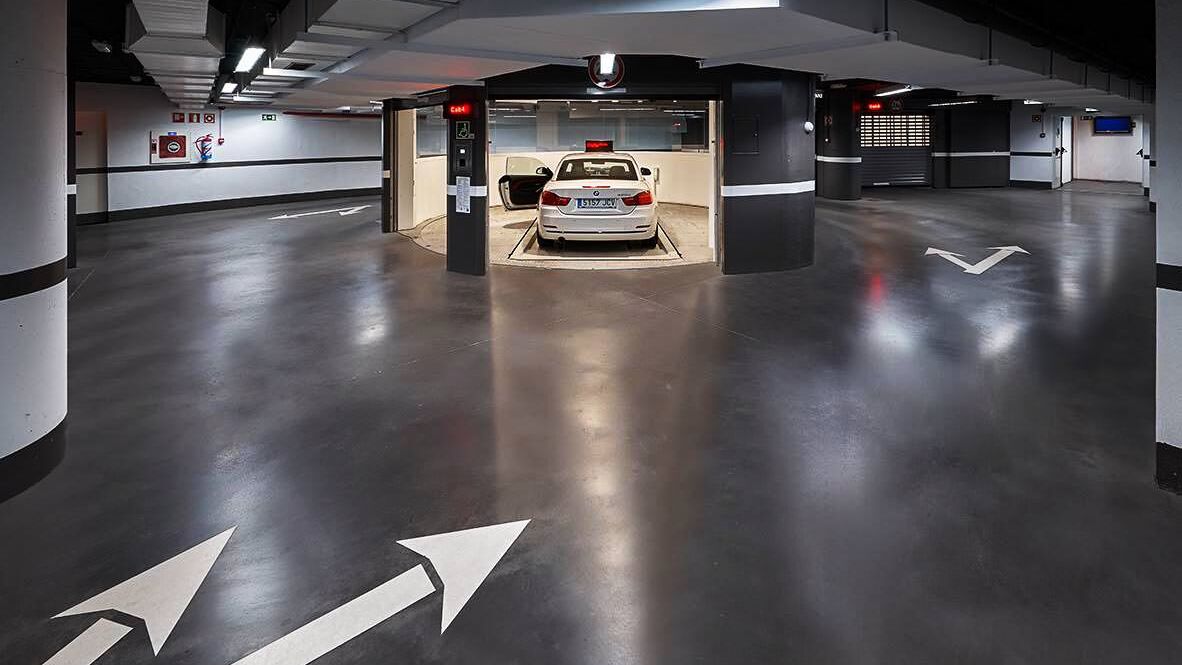 The car is parked in an entry bay on a parking platform